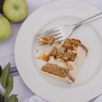 A slice of apple spice cake on a plate.