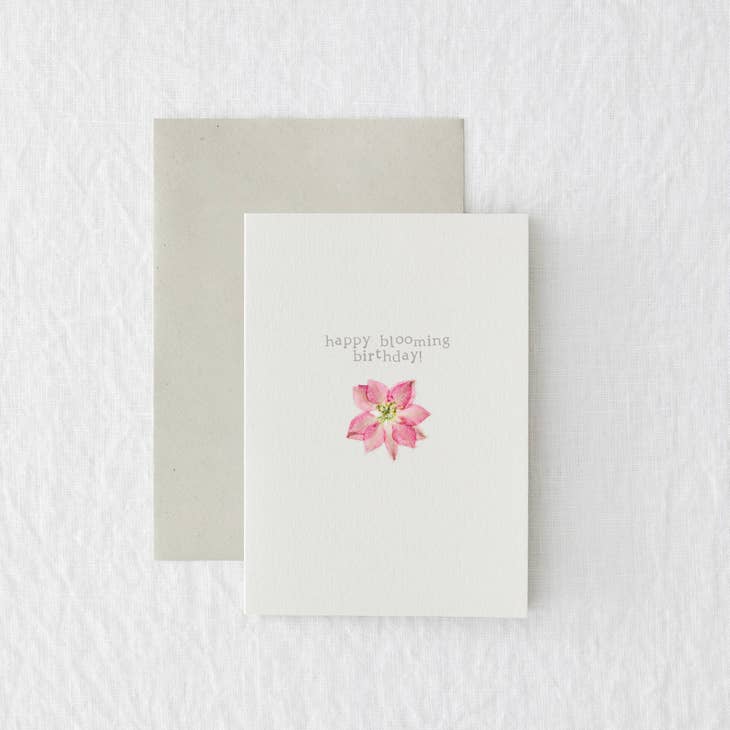 A white card with a pink pressed flower. "happy blooming birthday!"